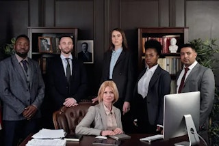 Group of paralegals and lawyers around a desk